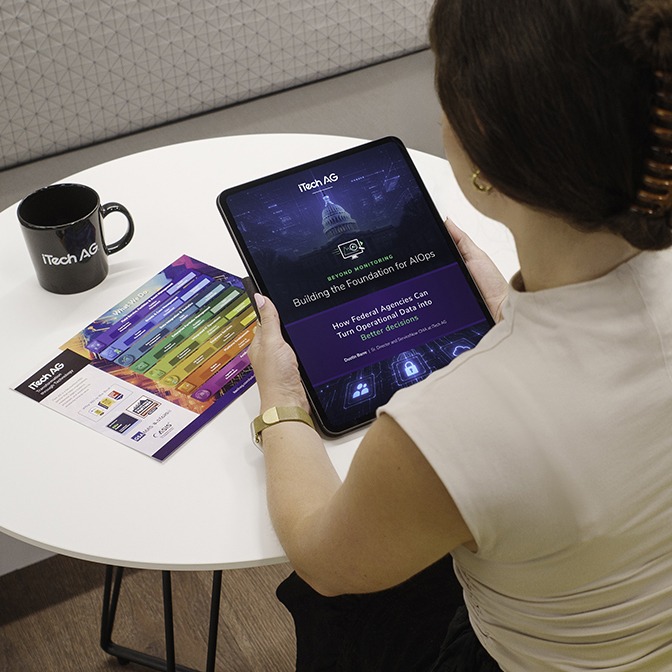 Person viewing the iTech AG AIOps eBook on an iPad